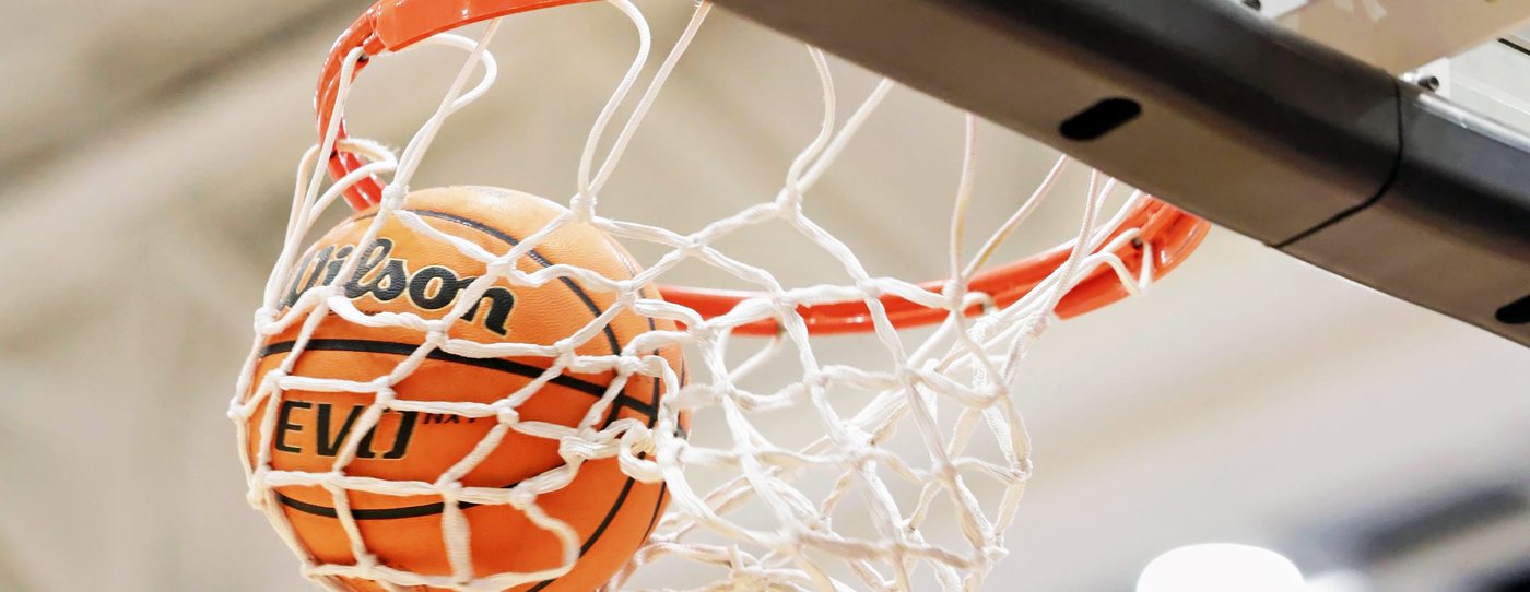 A basketball dropping through the net